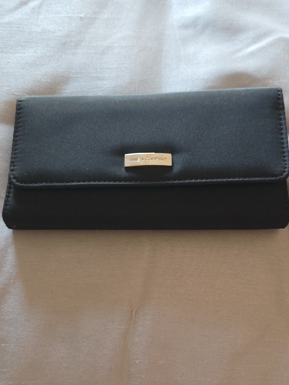 Nine & Co. Black Women's Clutch Wallet with Silver Logo Plaque